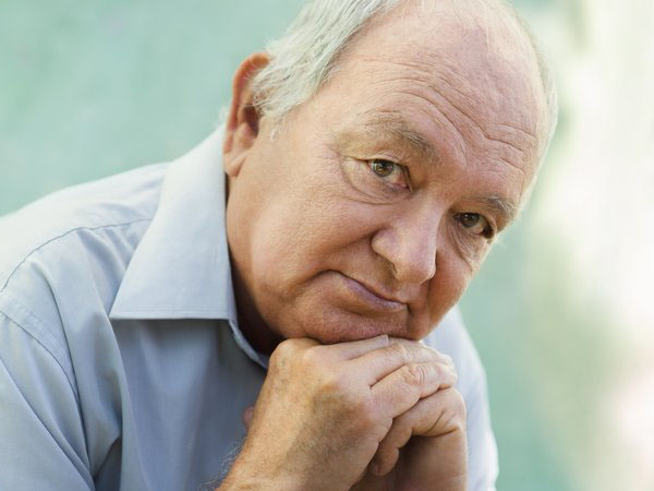Retired Man Head Leaning On Hand